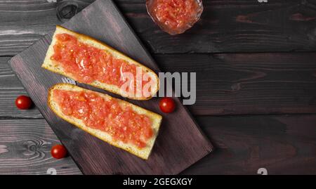 Toast à la tomate, petit déjeuner espagnol traditionnel. Huile d'olive, vue de dessus. Faire une casserole sur le tumka Banque D'Images