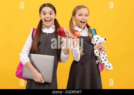 Un nouveau départ. Les enfants de l'école heureux tiennent des pommes. Collation scolaire. Ne vous inquiétez pas de manger des pommes. Banque D'Images