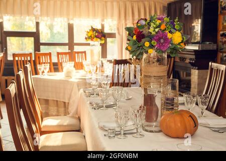 Décoration festive de style automnal avec numérotation des tables sur citrouilles dans la salle de banquet. Floristerie et décoration d'événements arrangements floraux. Banque D'Images