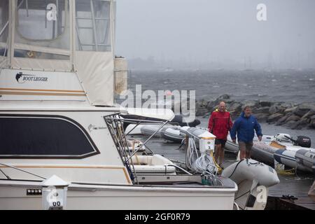 Cranston, États-Unis. 22 août 2021. Les membres du Rhode Island Yacht Club descendent le quai après avoir obtenu plusieurs bateaux au club pendant que la tempête tropicale Henri arrive à Cranston, Rhode Island, le dimanche 22 août 2020. La tempête tropicale Henri devrait causer des inondations et des coupures de courant dans tout le Connecticut et le Rhode Island. Photo par Matthew Healey/UPI crédit: UPI/Alay Live News Banque D'Images