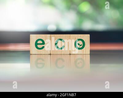 Mots écologiques verts avec symbole de feuille sur des blocs de cube en bois sur un bureau en bois brun et fond vert nature avec espace de copie. Énergie verte, écologie, ECO ven Banque D'Images