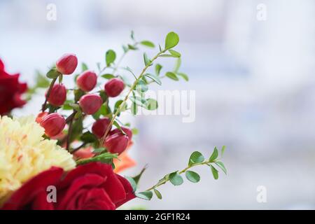 Partie du bouquet avec le bord des baies de barberge, feuilles vertes, rose rouge. Le concept des vacances. Copier l'espace. Photo de haute qualité Banque D'Images