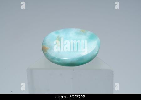 Pierre de larimar naturelle sur un stand sur fond blanc Banque D'Images