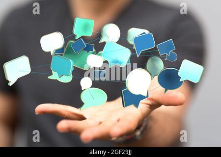 Main d'homme d'affaires tenant des icônes de communication colorées Banque D'Images