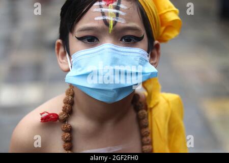 Katmandou, ne, Népal. 23 août 2021. Les enfants, vêtus de vêtements traditionnels, portent des masques de protection et des écrans faciaux lors de la célébration du festival Gai Jatra à Katmandou, au Népal, le 23 août 2021. Ce festival annuel est marqué dans un souvenir des membres de la famille et de la famille décédés. (Image de crédit : © Aryan Dhimal/ZUMA Press Wire) Banque D'Images