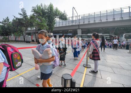 Changchun, province chinoise de Jilin. 23 août 2021. Les élèves du primaire font la queue pour entrer à l'école à Changchun, capitale de la province de Jilin, dans le nord-est de la Chine, le 23 août 2021. Les écoles primaires et secondaires de Changchun ont accueilli leurs nouveaux semestres lundi. Credit: Zhang Nan/Xinhua/Alay Live News Banque D'Images