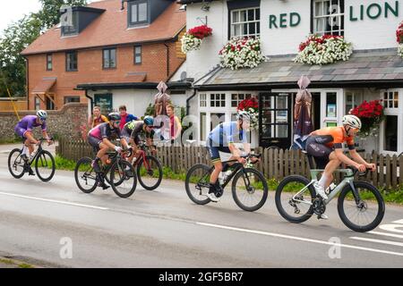 Les cyclistes qui participent à la course sur route Victor Berlemont Trophy 2021 autour de Woodcote dans l'Oxfordshire passent devant la maison publique Red Lion à Woodcote Banque D'Images