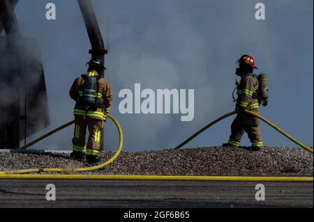 Les membres du Service des incendies de la base aérienne de Kirtland participent à un exercice de formation en direct sur les incendies à la base aérienne de Kirtland, au Nouveau-Mexique, le 18 août 2021. Au cours de l'exercice, un incendie d'avion a été simulé pour que les pompiers s'éteignent. Cette simulation a permis d'exercer l'état de préparation de la mission et les capacités de l'équipe et de ses stations partenaires. (É.-U. Photo de la Force aérienne par Senior Airman Ireland Summers) Banque D'Images