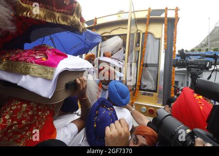 Les membres de Sikh riligion mettant 3 Saroops de Sri Guru Granth Sahib, l'écriture sacrée dans un bus à T3, aéroport IGI à New Delhi, Inde le 24 août 2021. Photo par Anshuman Akash/ABACAPRESS.COM crédit: Abaca Press/Alay Live News Banque D'Images