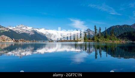 Lac Garibaldi, montagnes reflétées dans le lac glaciaire turquoise, la montagne de la Garde et le pic de déception, glacier derrière, Parc provincial Garibaldi, Britannique Banque D'Images