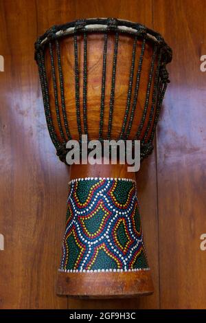 Instrument de musique djembe isolé sur fond de bois brun Banque D'Images