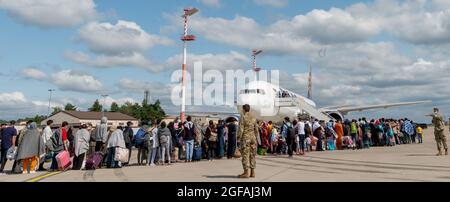 Ramstein Miesenbach, Allemagne. 24 août 2021. Les réfugiés afghans embarquaient à bord d'un avion commercial Atlas Air pour être transférés aux États-Unis après l'évacuation de Kaboul à la base aérienne de Ramstein le 24 août 2021 à Ramstein-Miesenbach, en Allemagne. Le Pentagone a appelé 18 avions civils de United Airlines, American Airlines, Delta Air, Atlas Air et Hawaiian Airlines en vertu de la loi sur la flotte aérienne de la Réserve civile pour aider à transférer les évacués dans le cadre de l'opération alliés refuge. Credit: Planetpix/Alamy Live News Banque D'Images