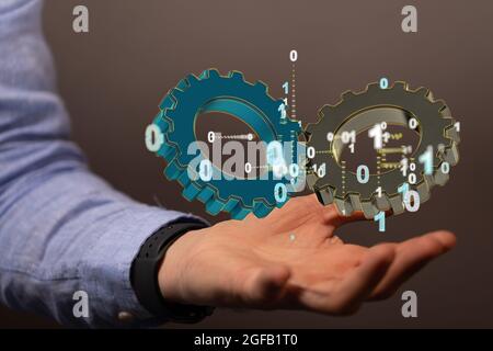 Main tenant un rendu flottant de grands engrenages avec code binaire flottant Banque D'Images