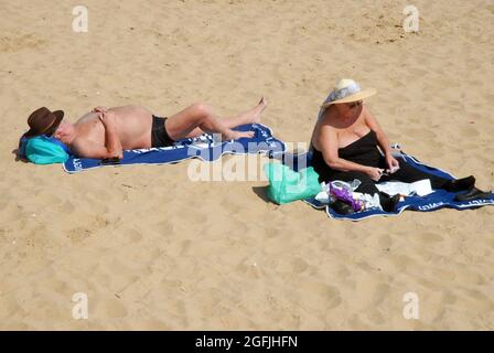 Vieux couple situé sur la plage, Cleethorpes, North East Lincolnshire, Angleterre. Banque D'Images