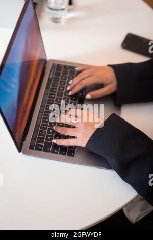Les mains de la femme sur le clavier d'ordinateur portable Banque D'Images