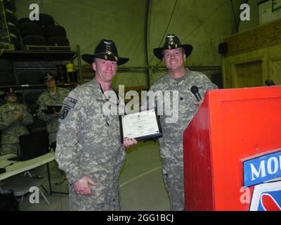 Le capitaine de l'armée américaine William Hanna, de West des Moines, en Iowa, reçoit un certificat de pilote en chef du lieutenant-colonel Christopher Downey, de l'armée américaine, de Philadelphie, commandant du jeu de tir de la Force opérationnelle. Hanna est la Compagnie A, le 2e Bataillon, le 10e Régiment d'aviation, le 10e Commandant de la brigade d'aviation de combat et un pilote UH-60 Black Hawk. (Photo de la SPC de l'armée américaine. Kam Gerohimos, jeu de tir Force de travail) Banque D'Images