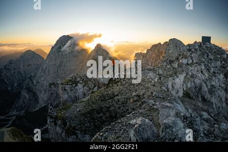 Homme au sommet de la colline regardant des paysages merveilleux dans les montagnes pendant l'été coucher de soleil coloré. Beau moment le miracle de la nature Banque D'Images