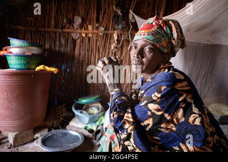 Une femme est assise dans son abri de fortune dans le camp de Senou, à la limite sud de Bamako, au Mali, où les personnes déplacées qui ont fui la violence dans le nord du pays ont cherché la sécurité. Banque D'Images