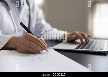 Gros plan jeune femme médecin généraliste notes manuscrites. Banque D'Images