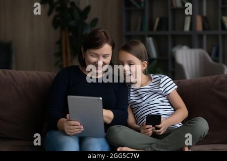 Accro à la technologie vieux granny et petit enfant en utilisant des gadgets. Banque D'Images