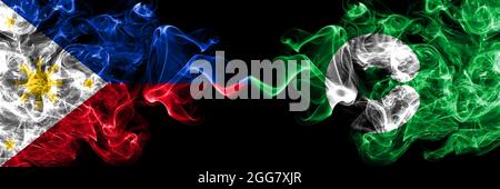 Philippines, Philippines vs Japon, Japonais, Kumamoto drapeau de fumée côte à côte. Banque D'Images