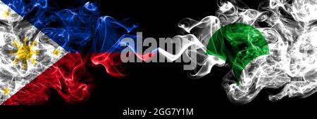 Philippines, Philippines vs Japon, Japonais, Tokyo drapeaux de fumée côte à côte. Banque D'Images