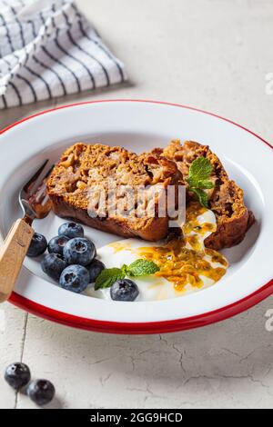 Tranches de tarte aux fruits végétaliens avec crème, baies et fruits de la passion, gros plan. Concept de dessert végétalien. Banque D'Images