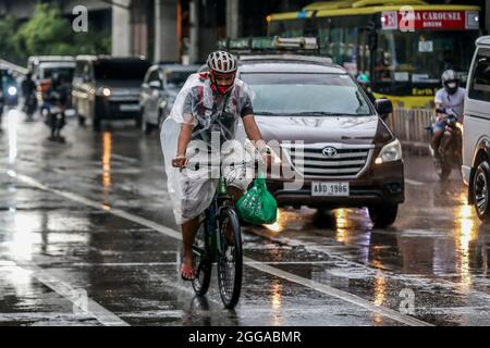 Quezon City, Philippines. 30 août 2021. Un homme portant un masque de visage fait un vélo à Quezon City, aux Philippines, le 30 août 2021. Lundi, le ministère de la Santé des Philippines a signalé 22,366 nouveaux cas de COVID-19, soit la plus forte augmentation d'un jour depuis le début de la pandémie, ce qui porte le nombre total de cas confirmés dans le pays à 1,976,202. Le DOH a également enregistré 222 décès liés au coronavirus, ce qui porte le nombre de décès dans le pays à 33,330. Crédit: Rouelle Umali/Xinhua/Alamy Live News Banque D'Images