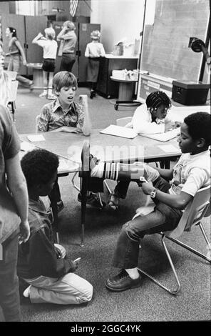 Austin Texas USA, 1984 : Patrick Skeaton, étudiant noir de quatrième année, qui a perdu sa jambe droite à cause du spina bifida, interagit à l'école primaire Wooten avec sa nouvelle prothèse de jambe. Fait partie d'une fonction photo étendue. ©Bob Daemmrich Banque D'Images