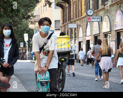 MILAN, ITALIE - 08 août 2021 : un pilote de livraison de nourriture « Glovo » dans une rue bondée de Milan, Italie Banque D'Images