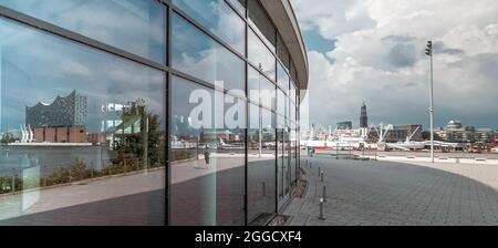 Hambourg, Allemagne. 14 juillet 2021. L'Elbphilharmonie de Hambourg se reflète dans la façade du 'Théâtre im Hafen', où se produit la comédie musicale 'le Roi Lion'. Credit: Markus Scholz/dpa/Alay Live News Banque D'Images