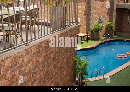 Petite piscine dans résidence privée de luxe, avec tables et chaises autour, plantes décoratives Banque D'Images