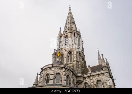 Tours et ange doré de la cathédrale de Cork dans le sud de l'irlande un jour gris typique du pays Banque D'Images