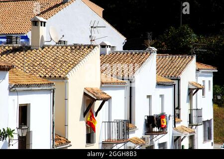 Maisons de ville avec drapeaux espagnols sur les balcons, Benahavis, Espagne. Banque D'Images