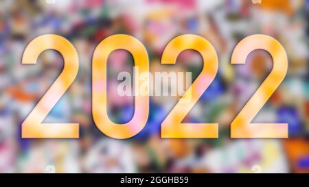 Texte de la nouvelle année 2022 réalisé avec des photographies d'éléments de couleur avec le fond hors foyer. Banque D'Images
