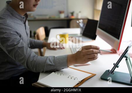 Un homme court d'analyse de l'investissement boursier sur ordinateur au bureau. Banque D'Images