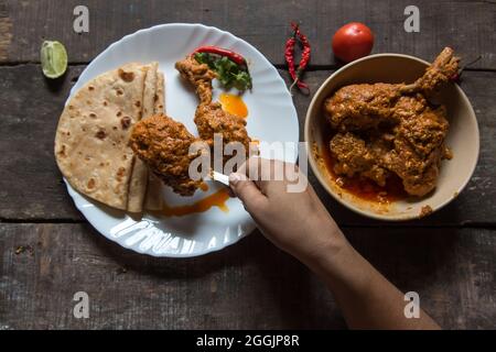 Main de la femme servant des aliments cuits sur une assiette avec l'utilisation de focus sélectif. Banque D'Images