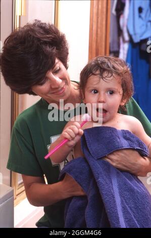 Austin Texas USA,1995: La mère tient son fils de 19 mois après son bain. ©Bob Daemmrich Banque D'Images