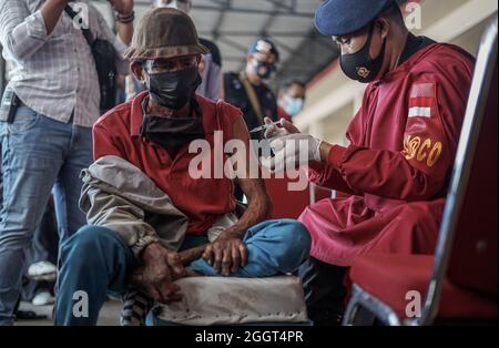 Makassar, Sulawesi du Sud, Indonésie. 3 septembre 2021. Un mendiant qui est également une personne handicapée est injecté avec un vaccin Covid-19 par des agents de santé de la brigade mobile de police de Sulawesi Sud. Cette activité de vaccination gratuite a été effectuée au quartier général de la brigade mobile de la police de Sulawesi du Sud pour atteindre l'objectif de vaccination des Sulawesi du Sud, jusqu'à 80 pour cent. (Credit image: © Herwin Bahar/ZUMA Press Wire) Credit: ZUMA Press, Inc./Alamy Live News Banque D'Images