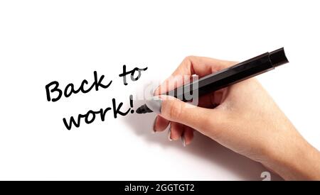 Écrire à la main sur le papier pour revenir au travail Banque D'Images