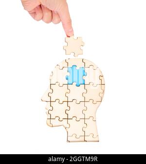 Placer la pièce cérébrale manquante du puzzle formant une tête humaine isolée sur blanc. Concept de psychothérapie. Banque D'Images