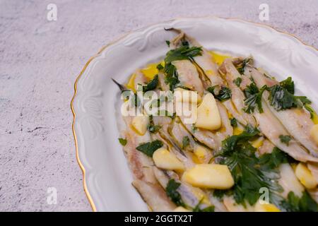 Anchois marinés dans du vinaigre et de l'huile d'olive avec du persil et de l'ail. Banque D'Images