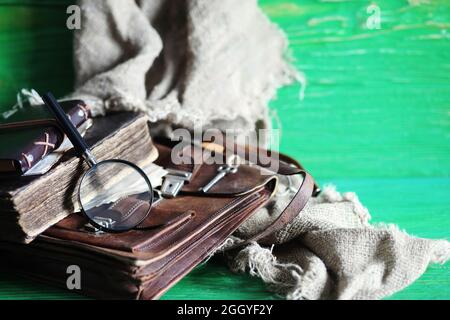 Vieux sac en cuir avec une loupe sur une table en bois brun voyageur espace de copie de fond. Banque D'Images