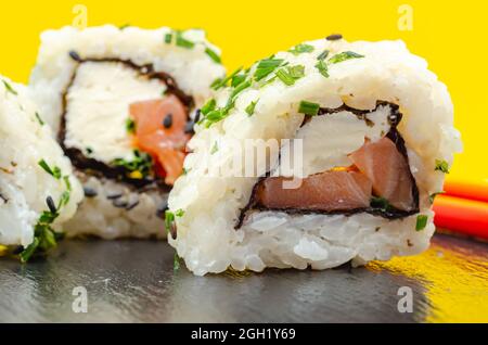 Gros plan sur le saumon fumé, le fromage doux et le rouleau de ciboulette californien, cuisine japonaise traditionnelle Banque D'Images