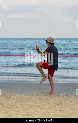 Tel Aviv, Israël - 16 août 2021 : un homme pratiquant le Tai Chi sur la plage de tel Aviv, Israël, à l'aube. Banque D'Images