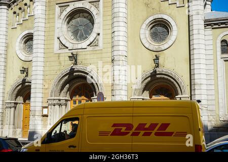 Bucarest, Roumanie - 30 août 2021 une camionnette jaune DHL est garée devant l'église luthérienne, dans la rue luthérienne de Bucarest. Banque D'Images