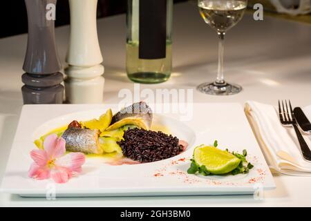 Filet de poisson Dorado cuit avec garniture de riz rouge Banque D'Images