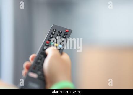 Regarder la télévision et utiliser la télécommande pour le gros plan Banque D'Images