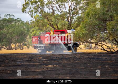 Un appareil d'incendie mettant un feu d'herbe, Langley Barfold, Victoria, Australie. Banque D'Images