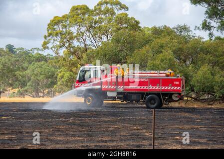 Un appareil d'incendie mettant un feu d'herbe, Langley Barfold, Victoria, Australie. Banque D'Images